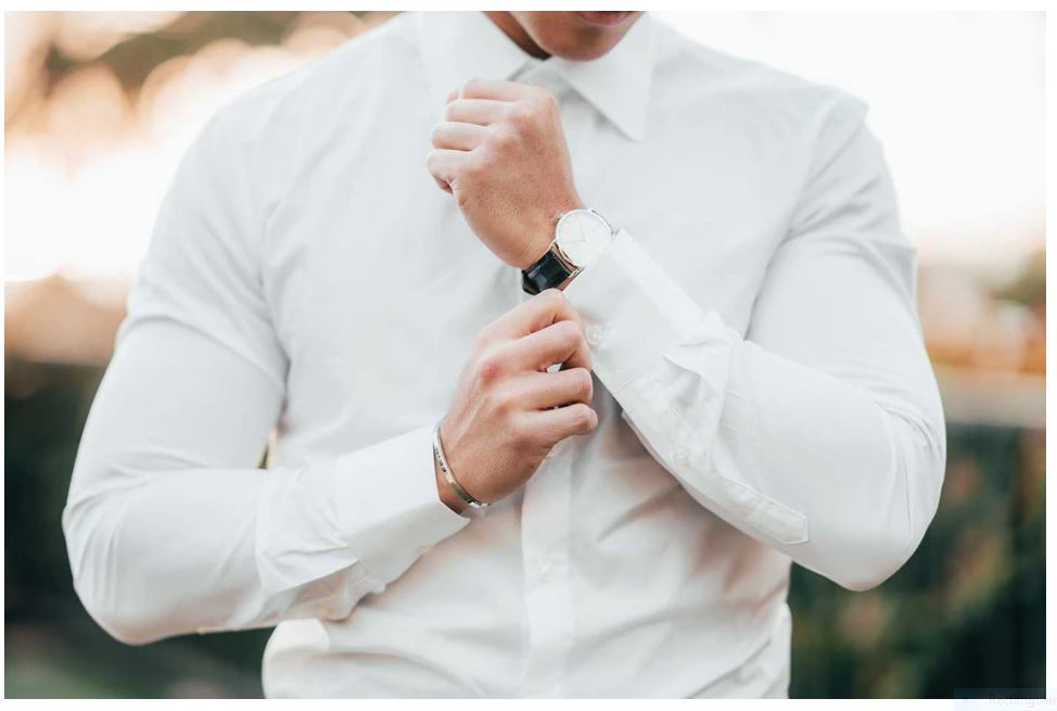 Man holding long shirt cuff