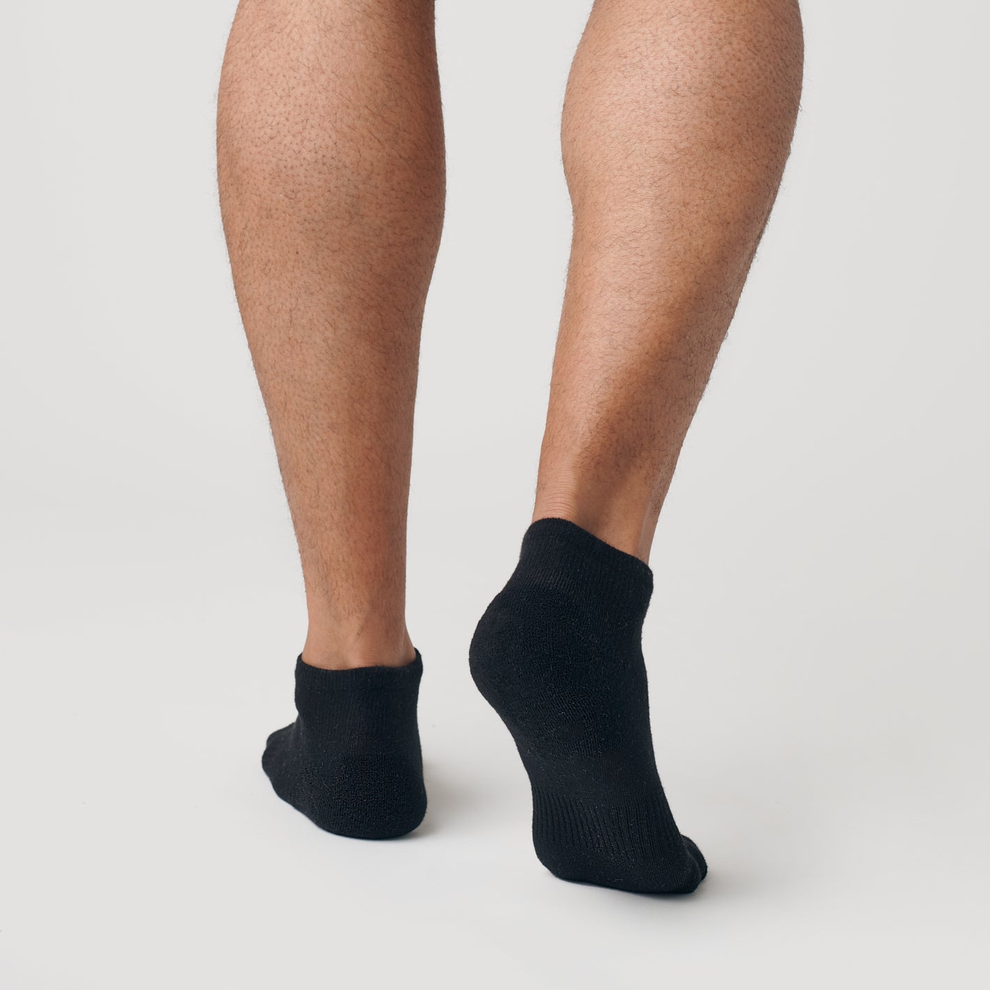 Black Ankle Socks 3-Pack on feet, showcasing seamless heel design.