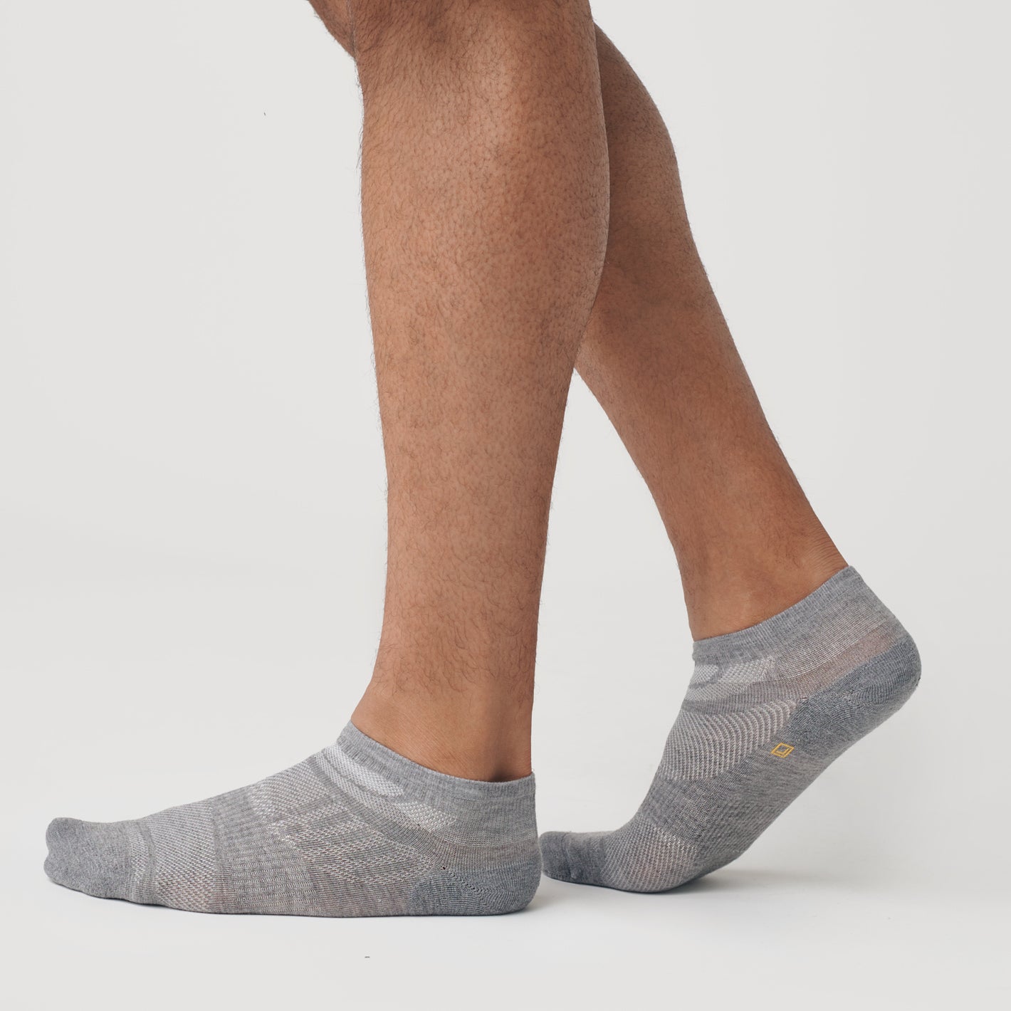 Heather Gray Ankle Socks 12-Pack on feet, showcasing ventilation panels.