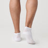 White Ankle Socks 12-Pack displayed on feet, showcasing seamless design.