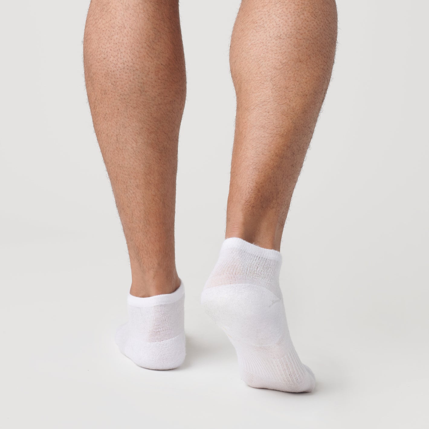 White Ankle Socks 12-Pack displayed on feet, showcasing seamless design.