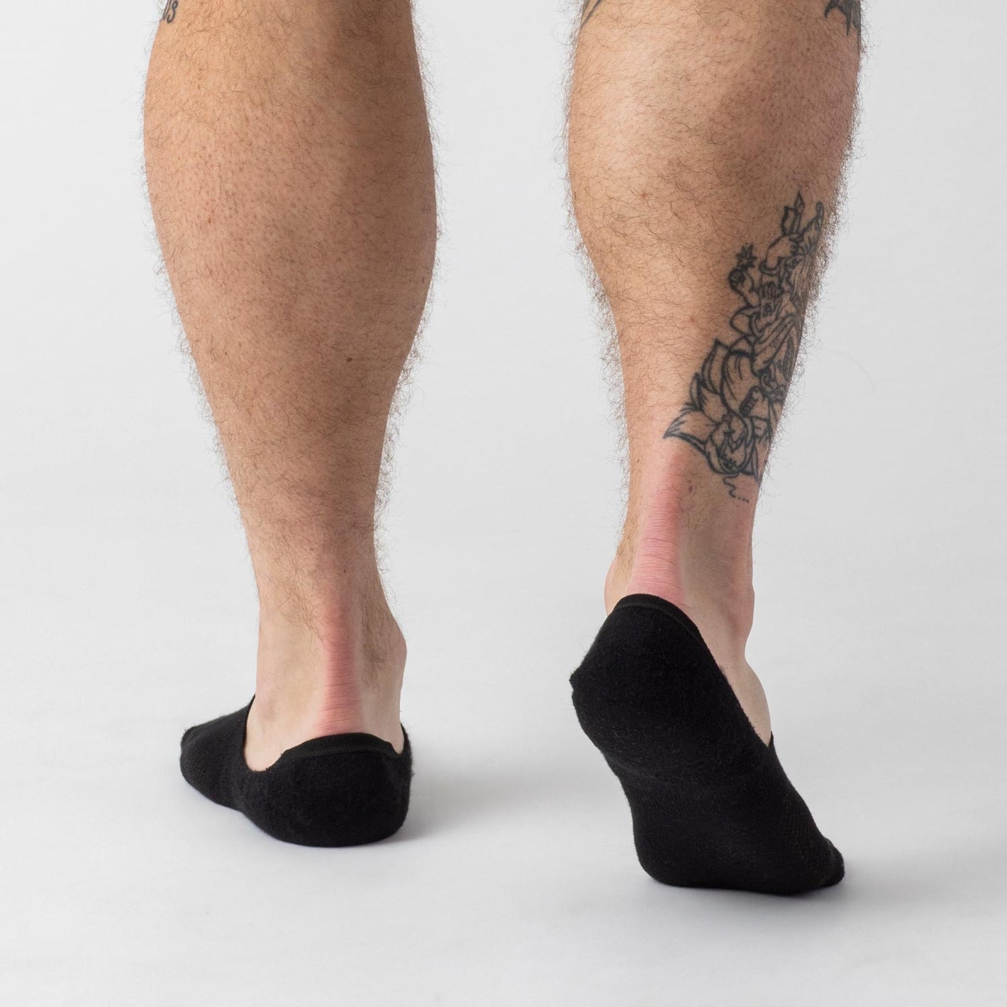 Black Never Show Socks 12-Pack on feet, featuring seamless toe and contour fit.