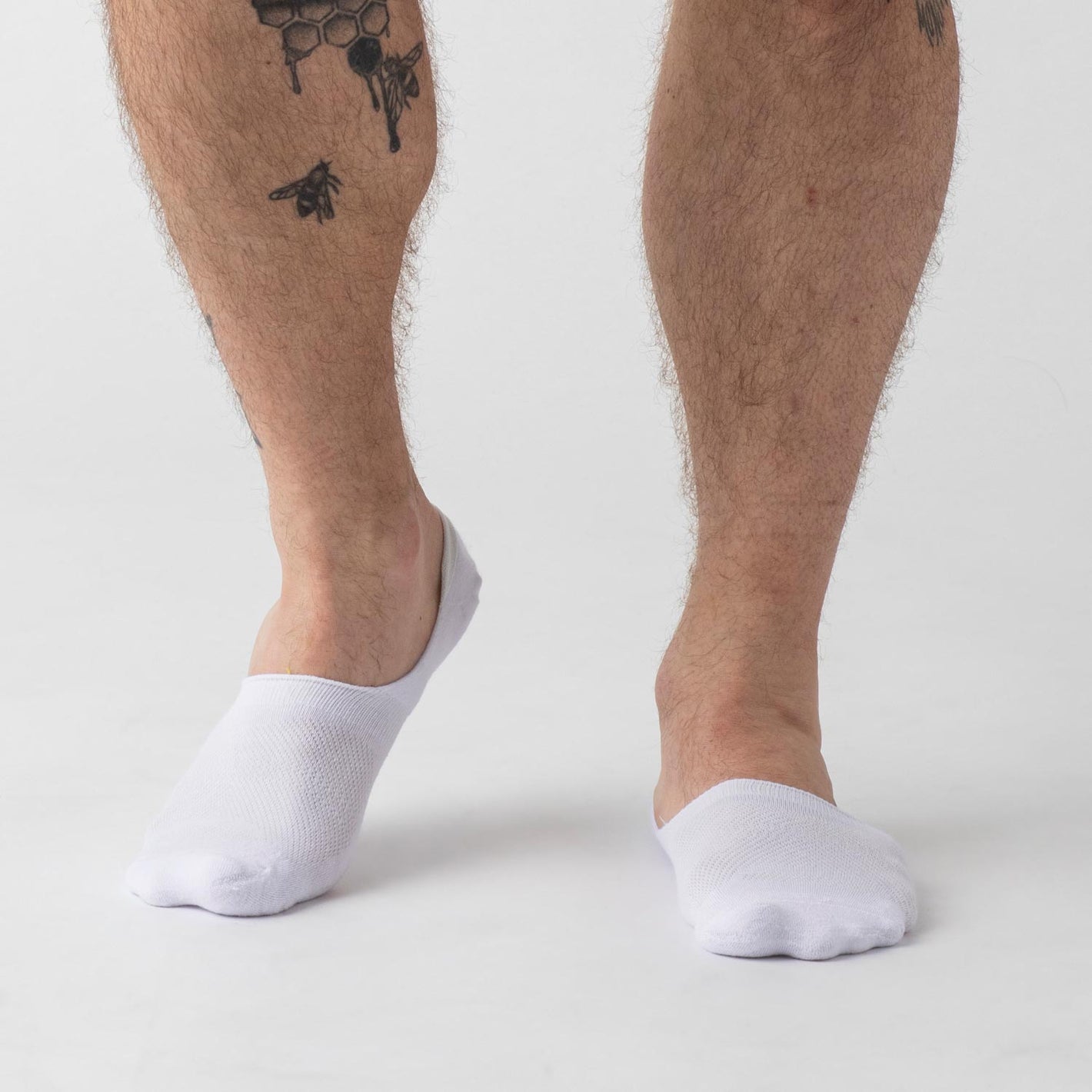 White Never Show Socks 3-Pack on male feet with honeycomb tattoo.