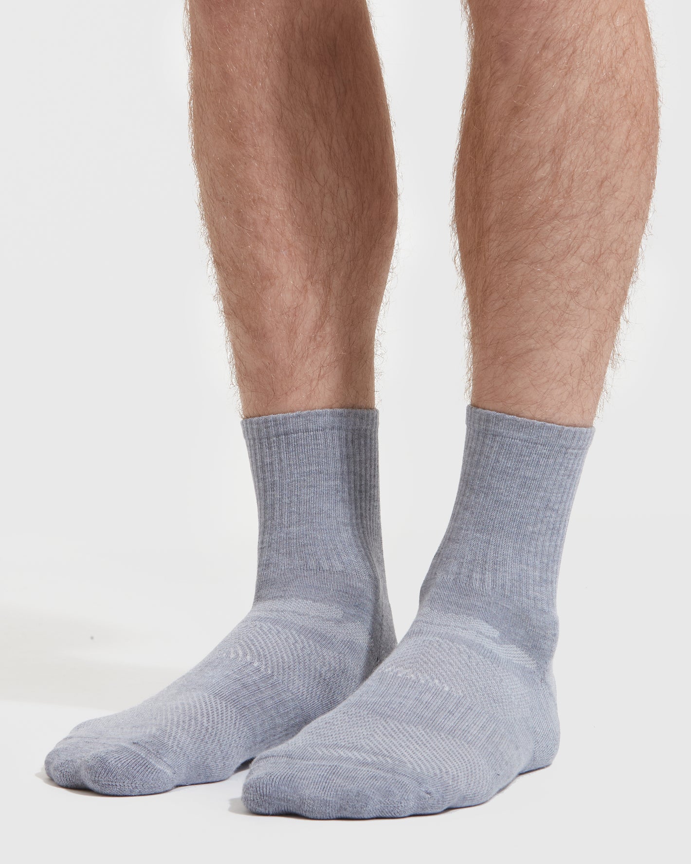 Heather Gray Half Crew Socks 3-Pack on legs, showcasing ribbed texture.
