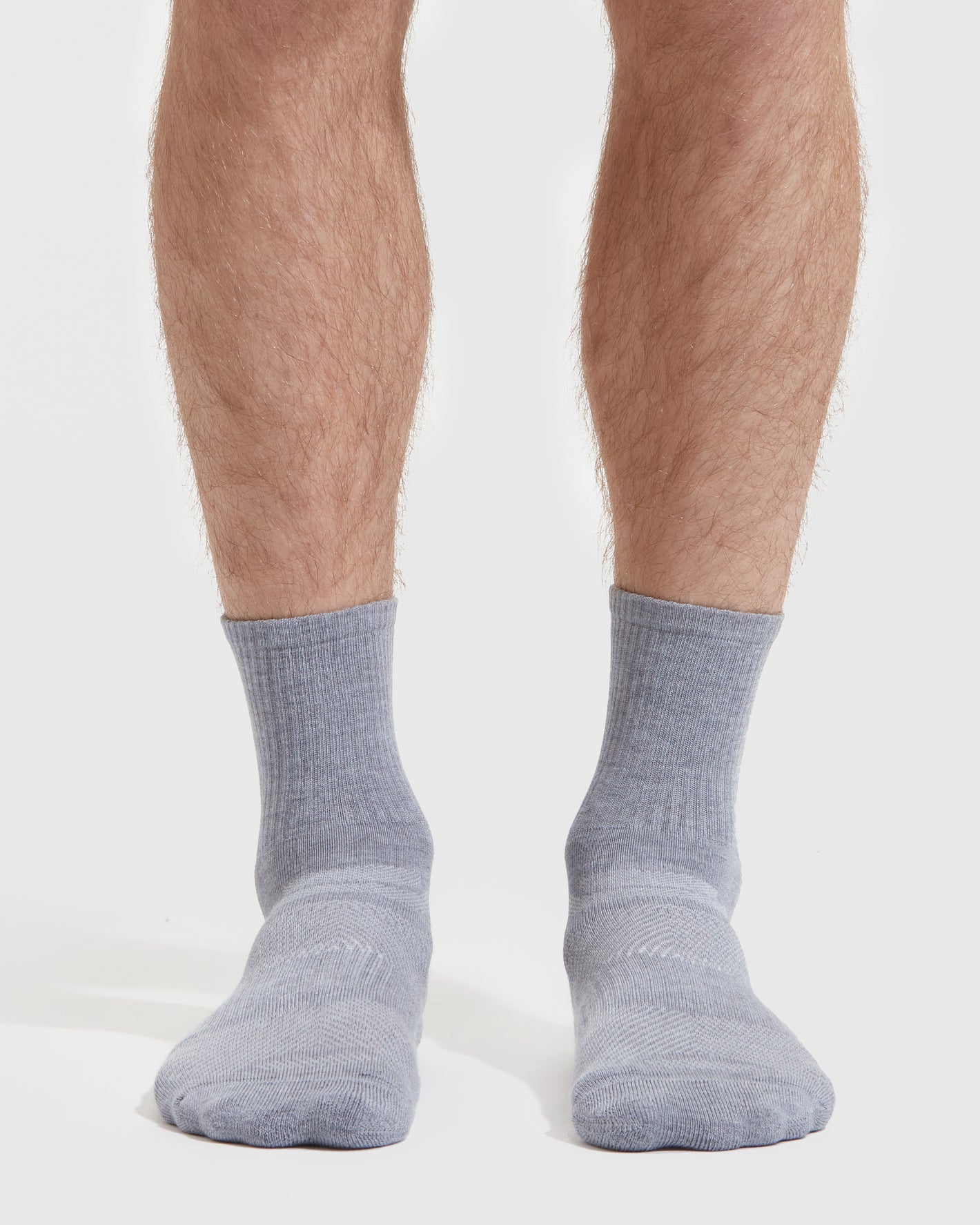 Heather Gray Half Crew Socks 3-Pack on feet, showcasing ribbed cuff and reinforced stitching.