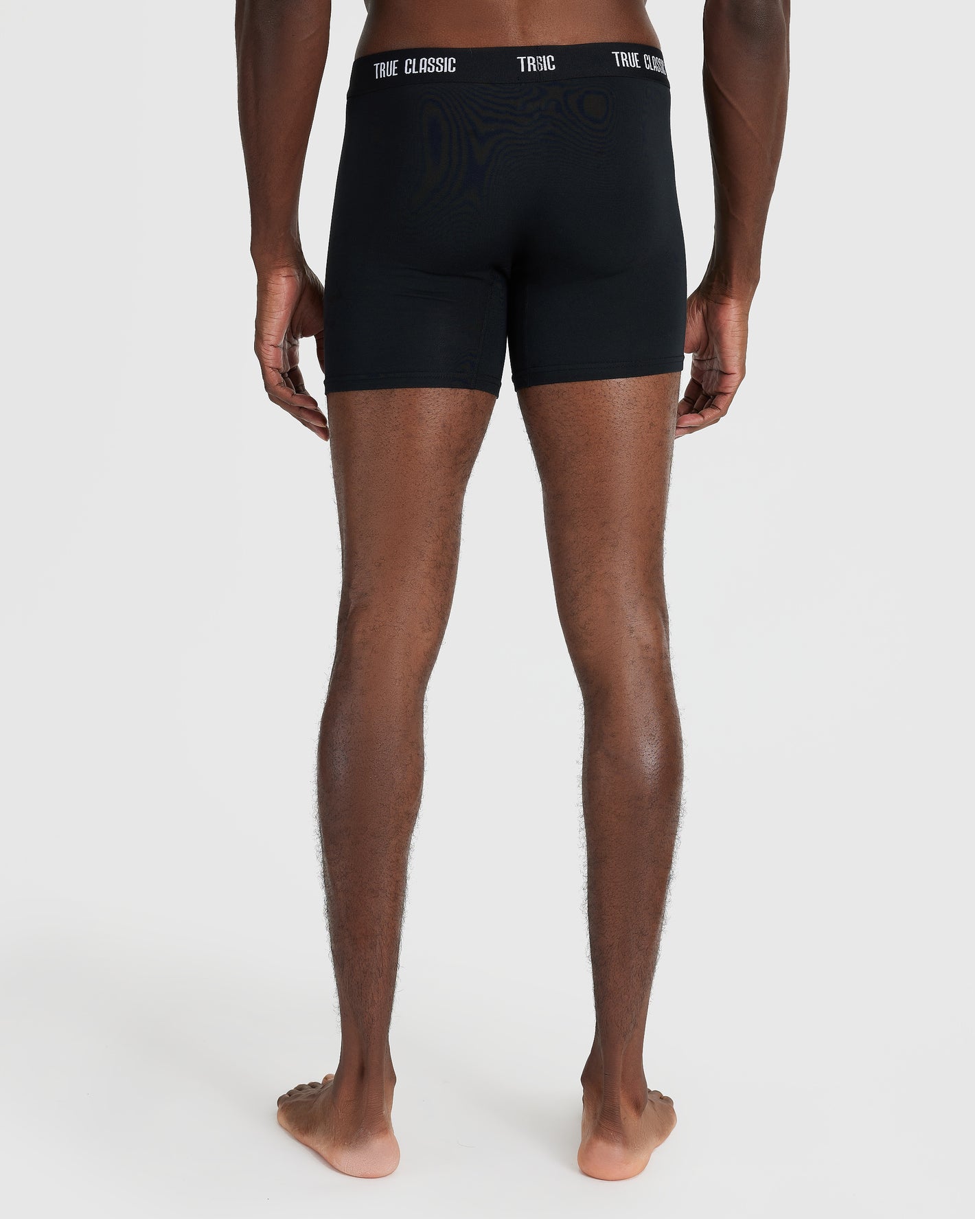 Back view of model in Black Logo Boxer Briefs 3-Pack.