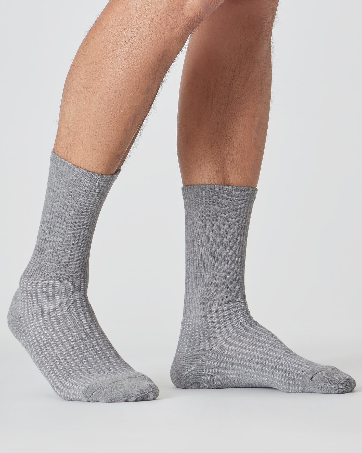 Heather Gray Active Half Crew Socks 12-Pack on legs, showcasing rib-knit texture.