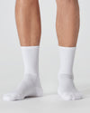 White Active Crew Socks 3-Pack on person’s legs, showcasing ribbed texture.