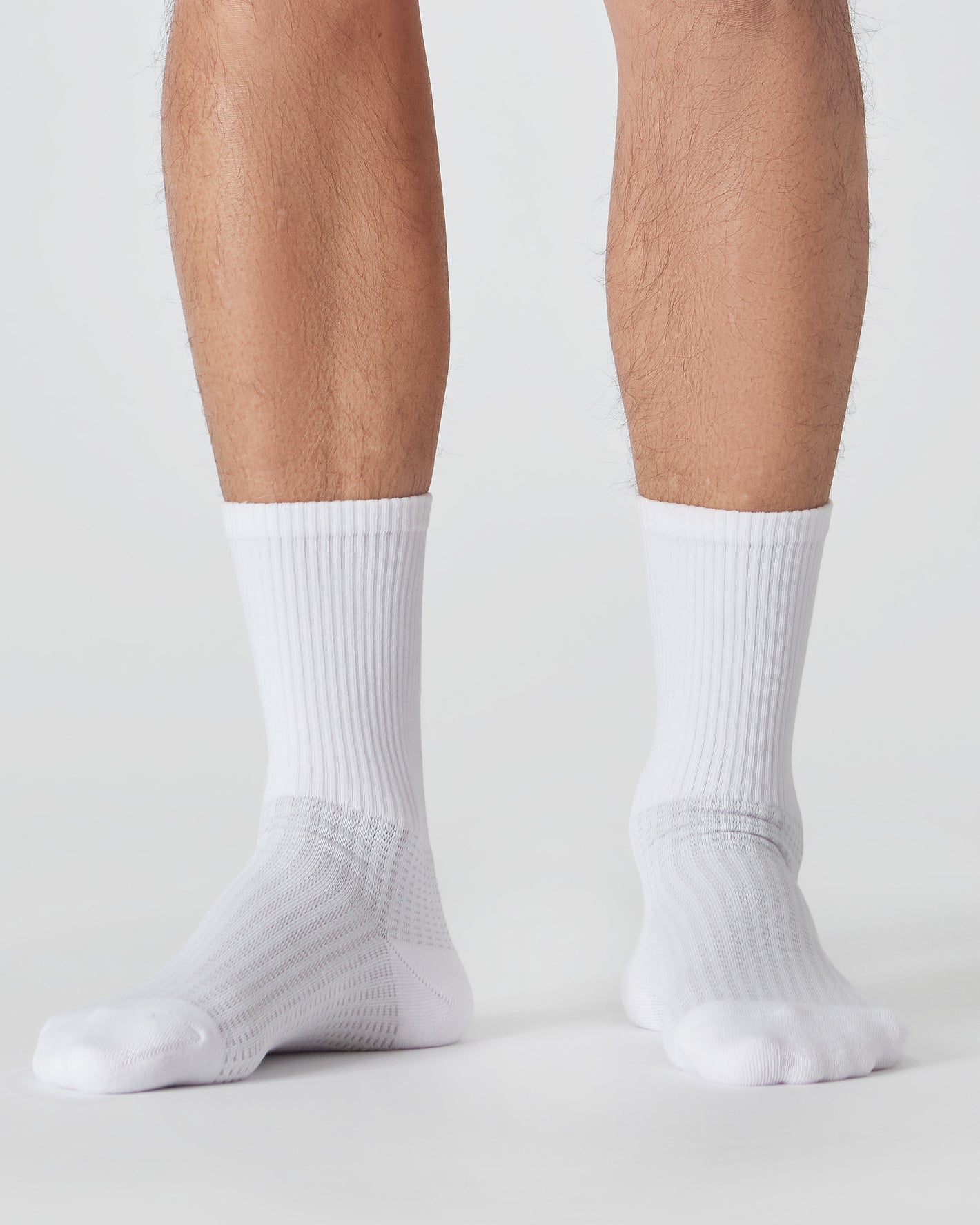 White Active Half Crew Socks 6-Pack on feet, showcasing ribbed texture.