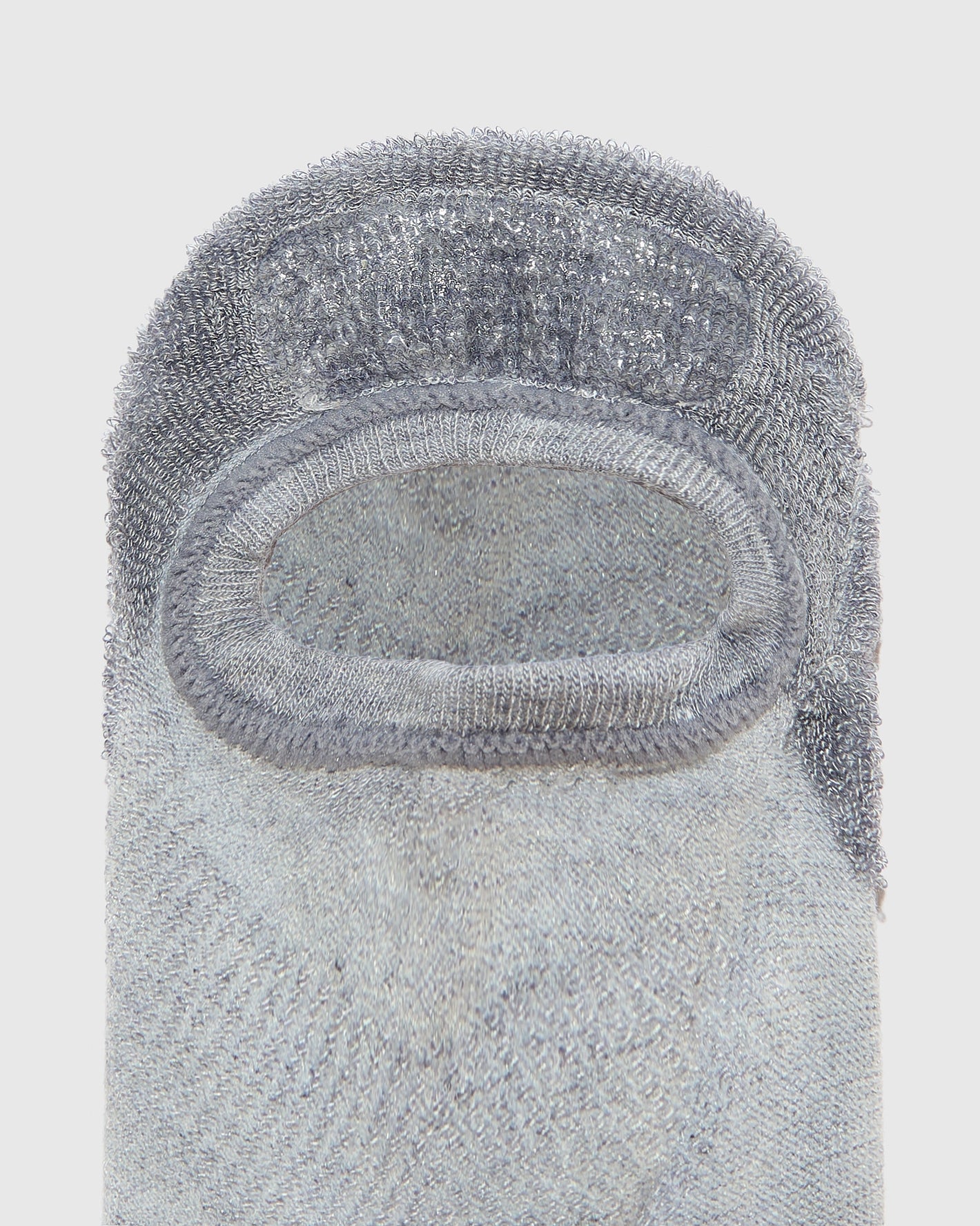 Heather Gray No Show Sock with rubber heel stop, laid flat.