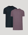 Two short-sleeve crew-neck t-shirts shown on a light gray background, with one in dark navy and the other in heathered muted purple, layered slightly behind each other.