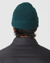 Evergreen Sweater Beanie on person, showcasing rib-knit design and folded cuff.
