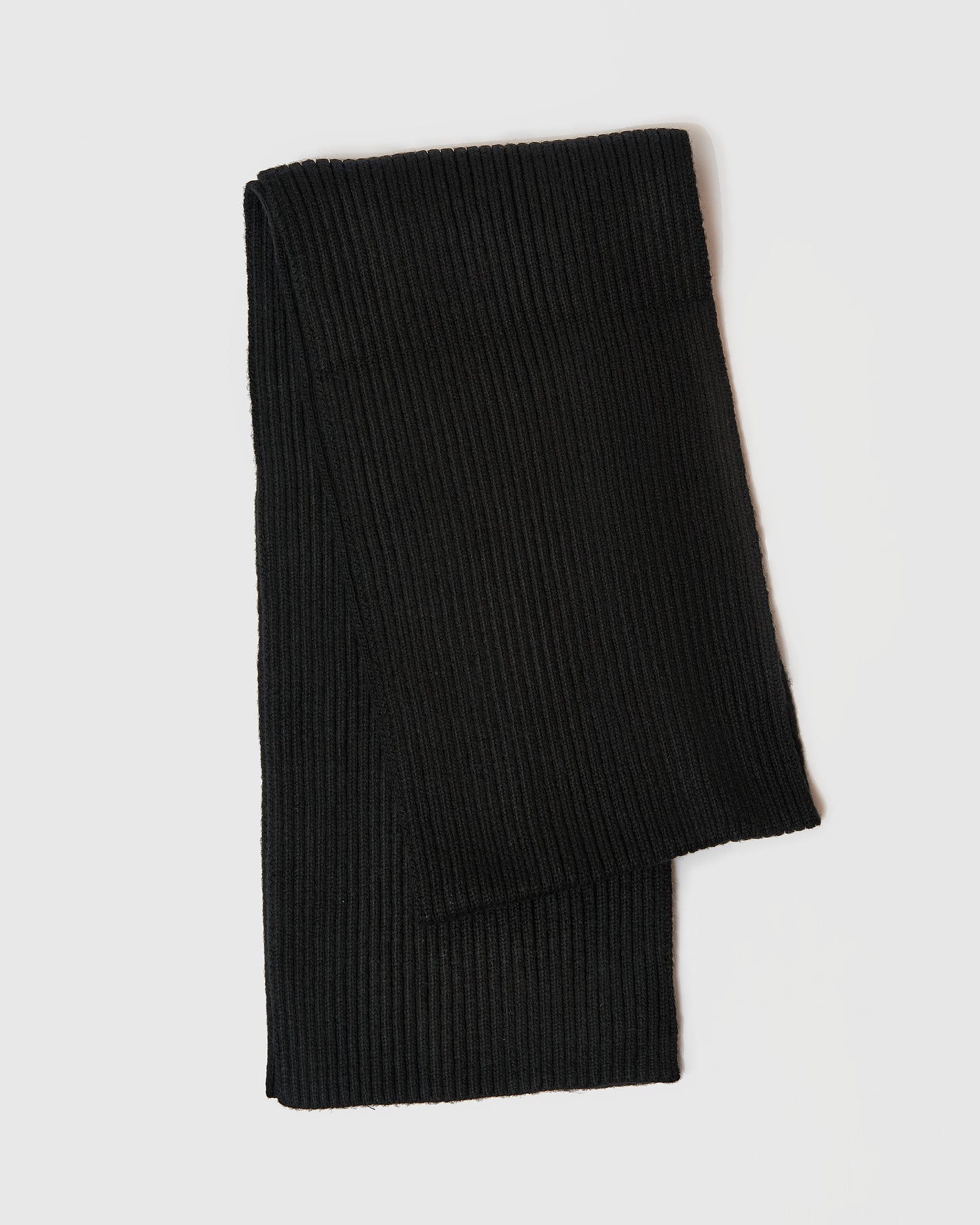 Black Sweater Scarf laid flat, showcasing rib-knit texture.