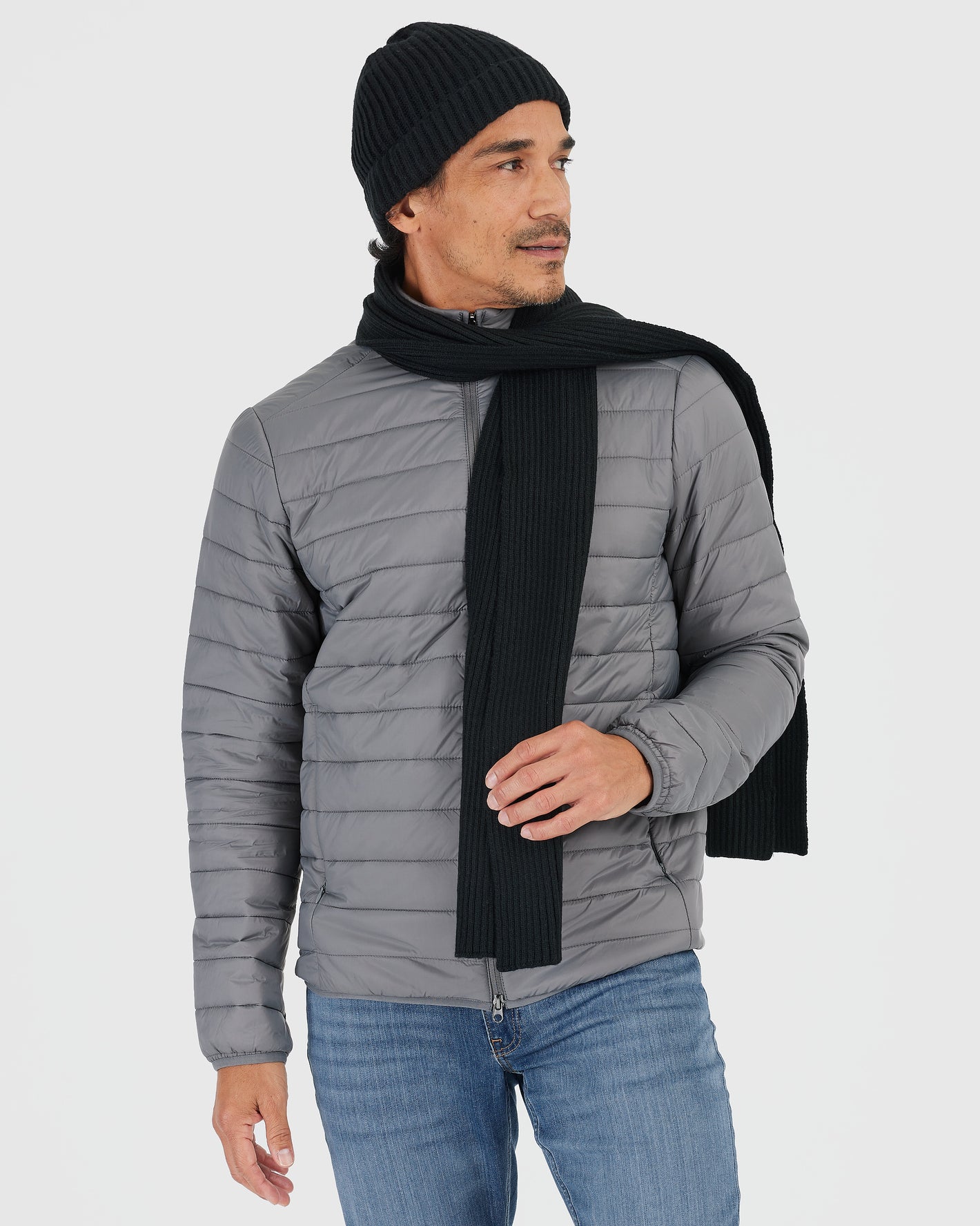 Man wearing Black Sweater Scarf with light-grey quilted jacket.