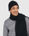 Man wearing Black Sweater Scarf and gray quilted jacket.