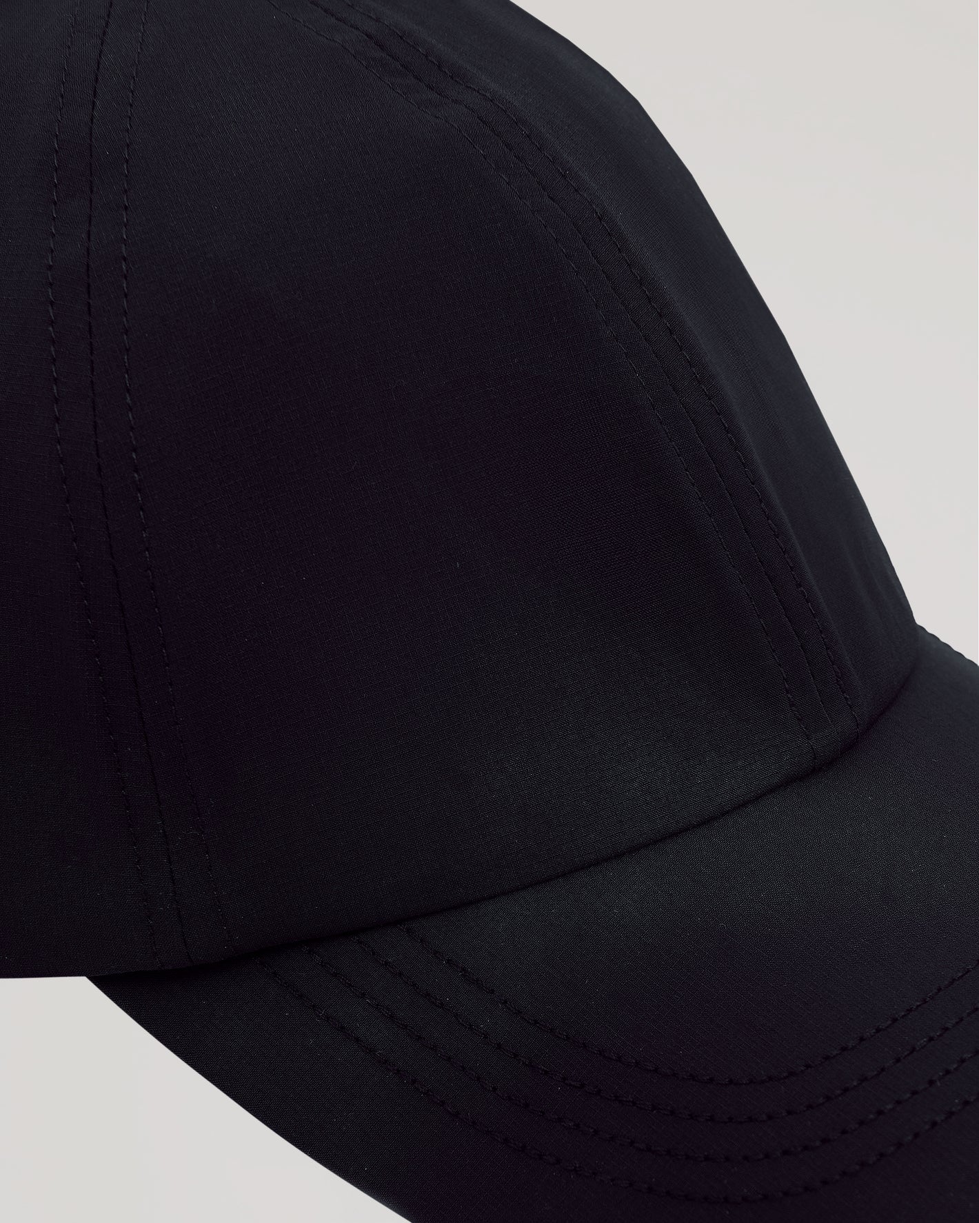 Black Active Running Cap with breathable fabric and adjustable closure.