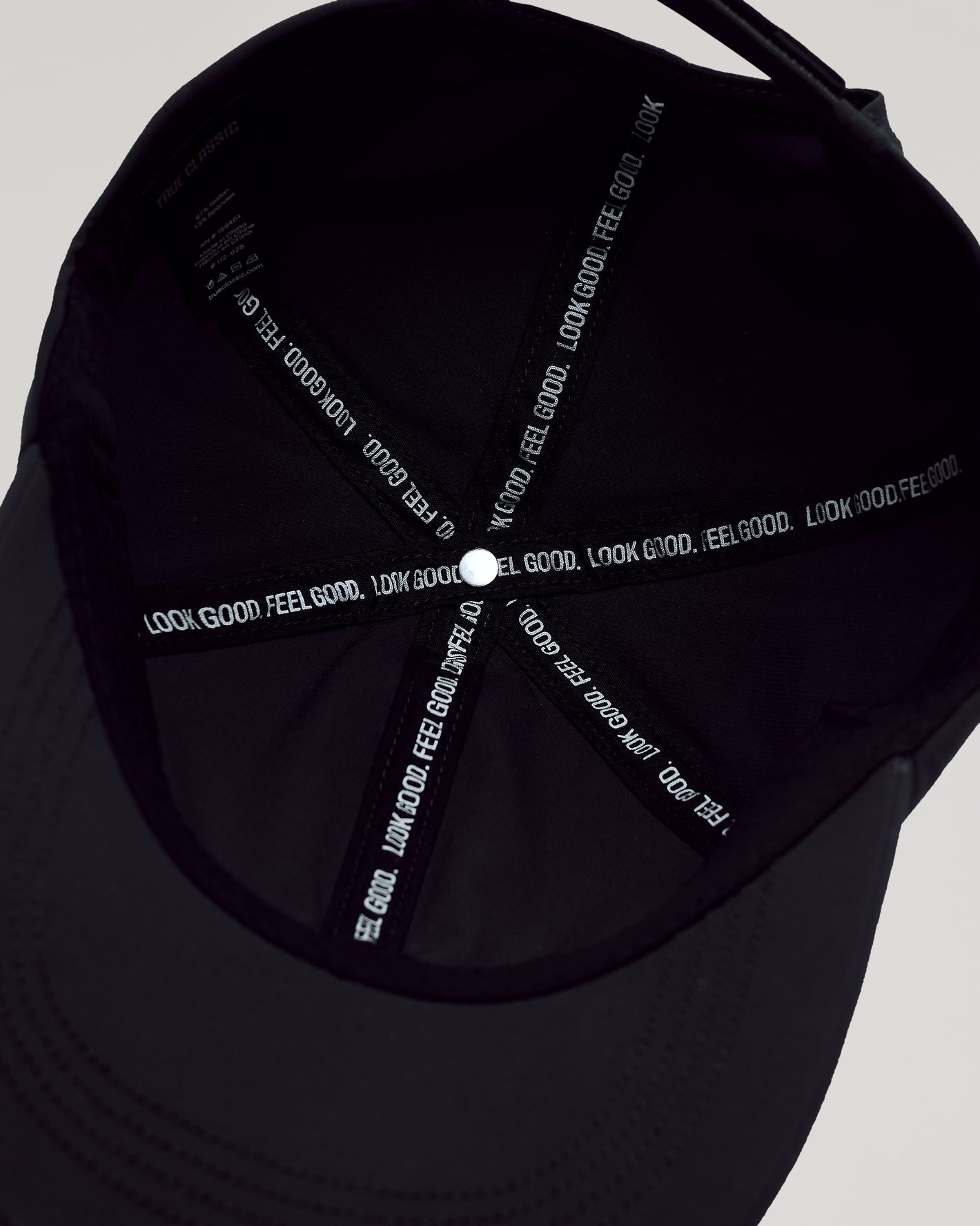 Black Active Running Cap inside view, showing “LOOK GOOD. FEEL GOOD.” slogan.