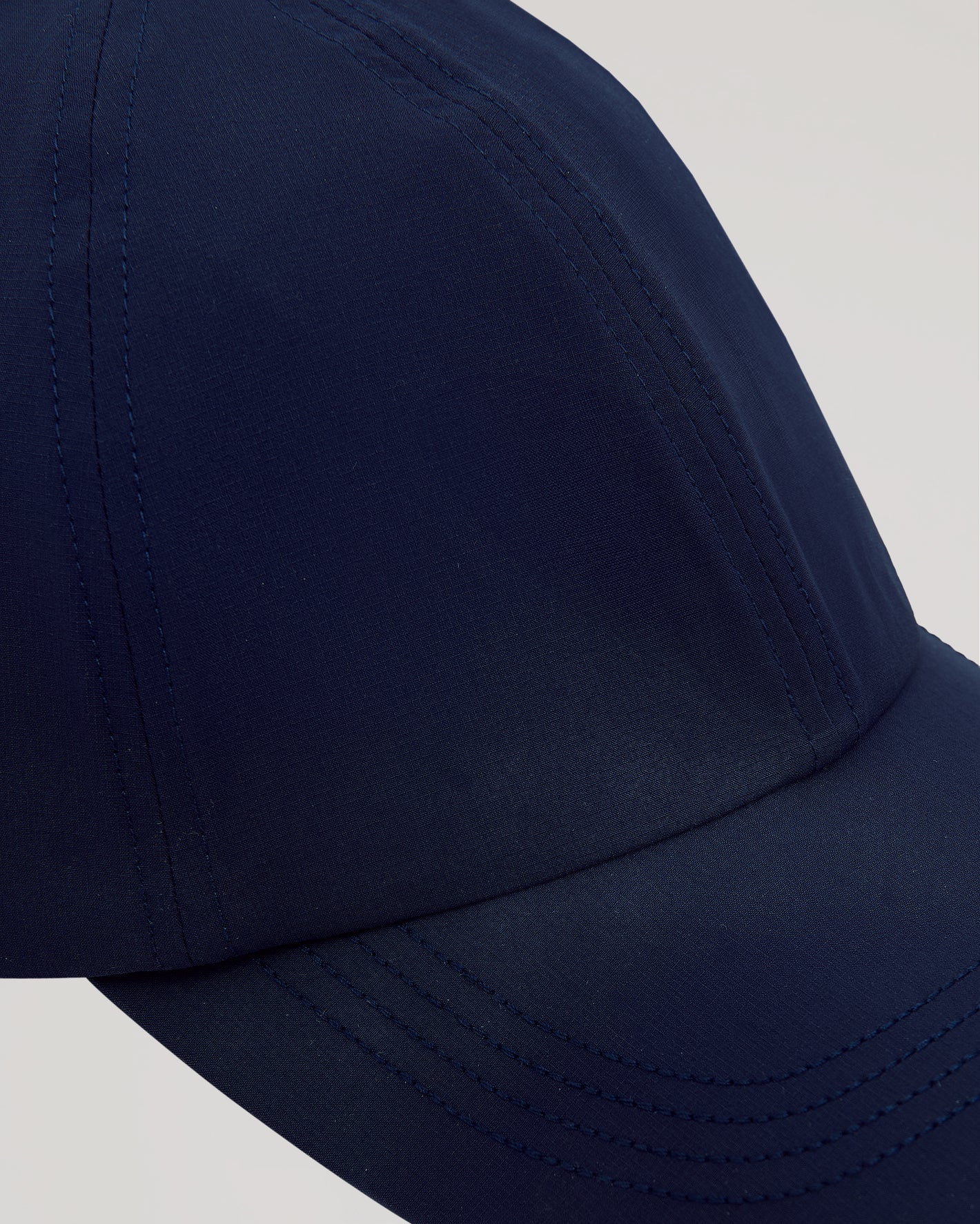 Navy Active Running Cap with curved brim and detailed stitching.