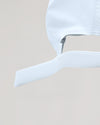 White Active Running Cap with adjustable Velcro strap, emphasizing its secure fit.