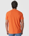 Man in Burnt Orange Heather Classic Crew Neck and jeans, back view.