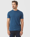 Man wearing Deep Sea Blue Classic Crew Neck, plain blue tee, relaxed fit.