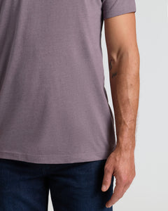 True ClassicDark Heather Amethyst Classic Crew Neck on person in jeans, tattoo visible.