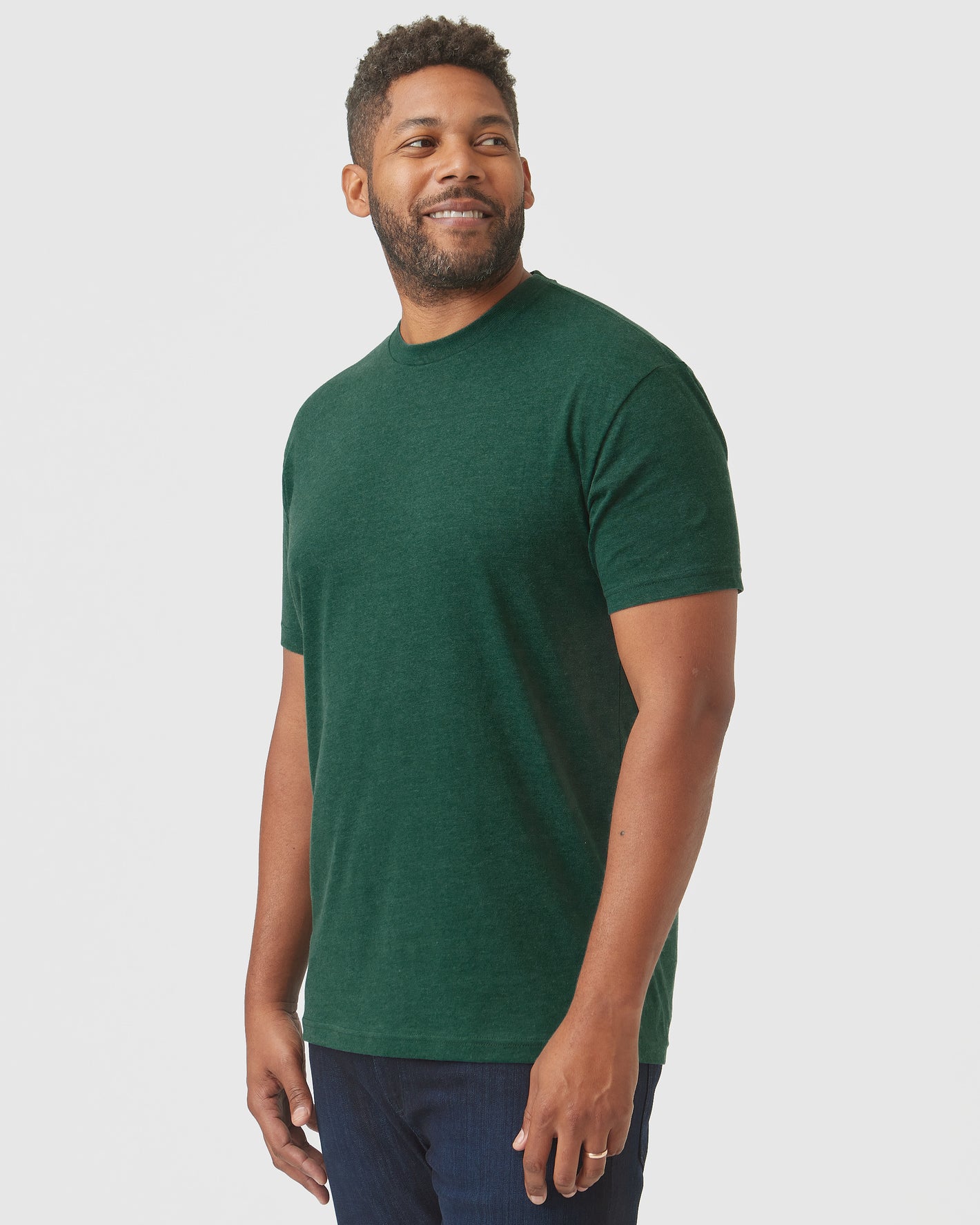 Man wearing Evergreen Heather Classic Crew Neck with dark blue jeans.