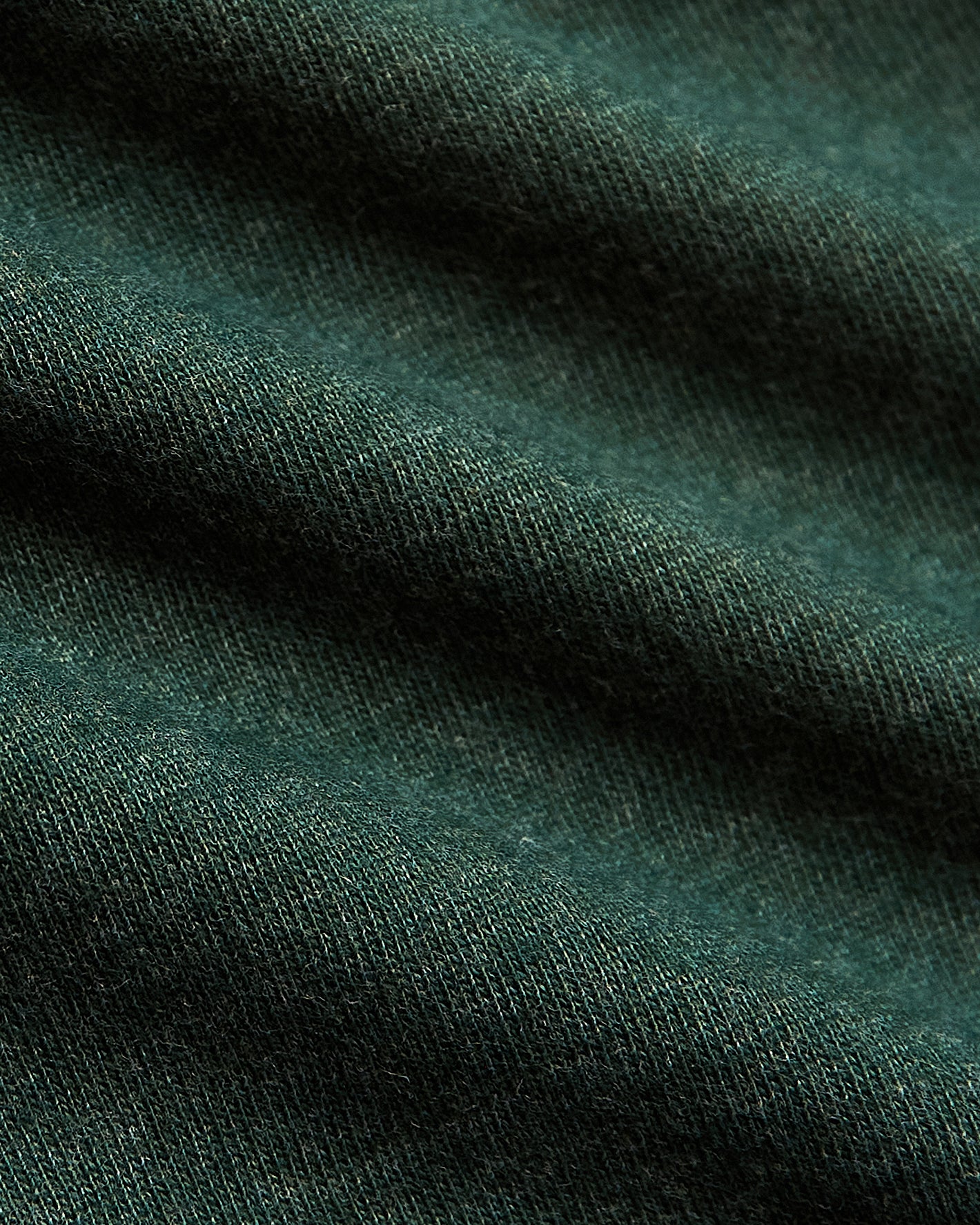Evergreen Heather Classic Crew Neck, textured dark green knit fabric close-up.