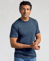 Man wearing Classic Crew Neck 6-Pack, heathered navy T-shirt, medium-wash jeans.