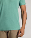Light Heather Greenery Classic Crew Neck worn with khaki trousers.