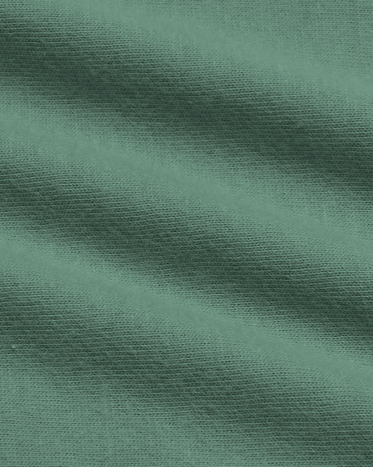 A close-up of textured fabric in a muted sage green color, showing the weave and soft diagonal folds.