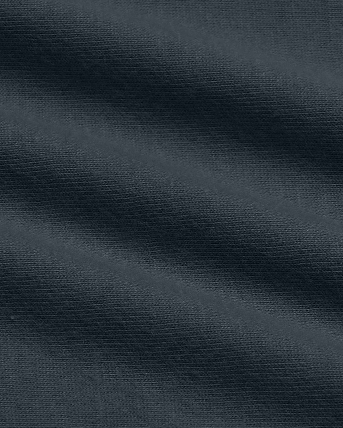 A close-up of dark navy blue fabric with a fine textured weave and soft diagonal folds.