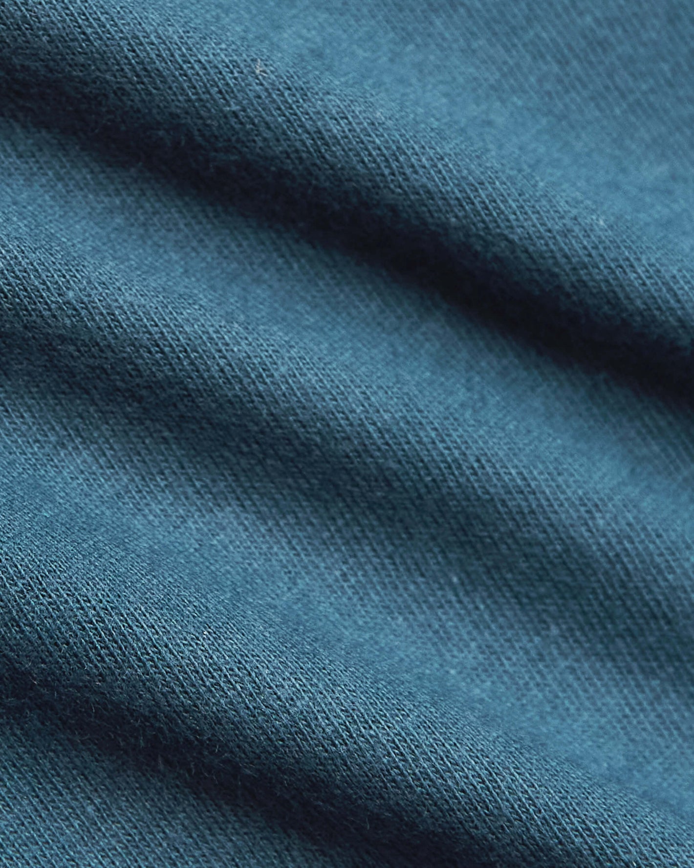 Sapphire Short Sleeve Crew Neck T Shirt's fine-knit, teal-blue fabric close-up.