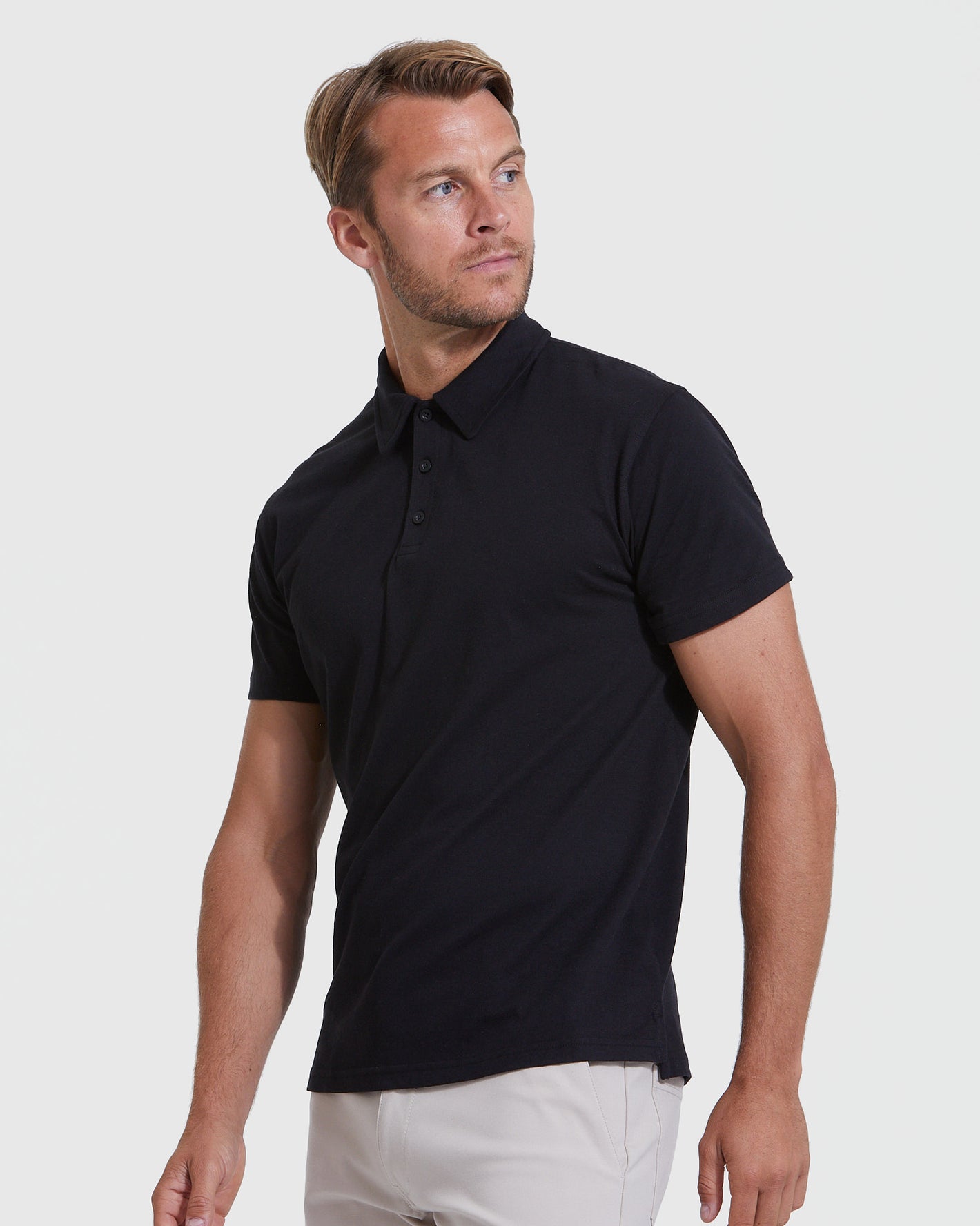 Black Classic Polo 3-Pack modeled by man in light pants.