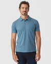 Blue Lake Heather Classic Polo worn by male model, paired with dark jeans.
