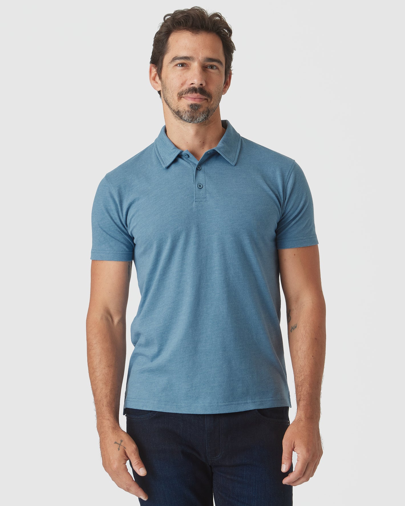 Blue Lake Heather Classic Polo worn by male model, paired with dark jeans.