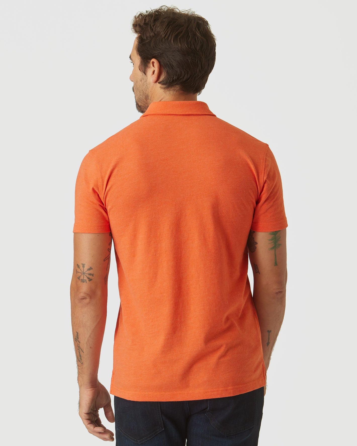Back view of model in Burnt Orange Heather Classic Polo.