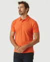 Man models Burnt Orange Heather Classic Polo, showcasing its fitted, athletic cut.