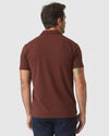 Back view of man in Dark Chocolate Classic Polo and jeans.