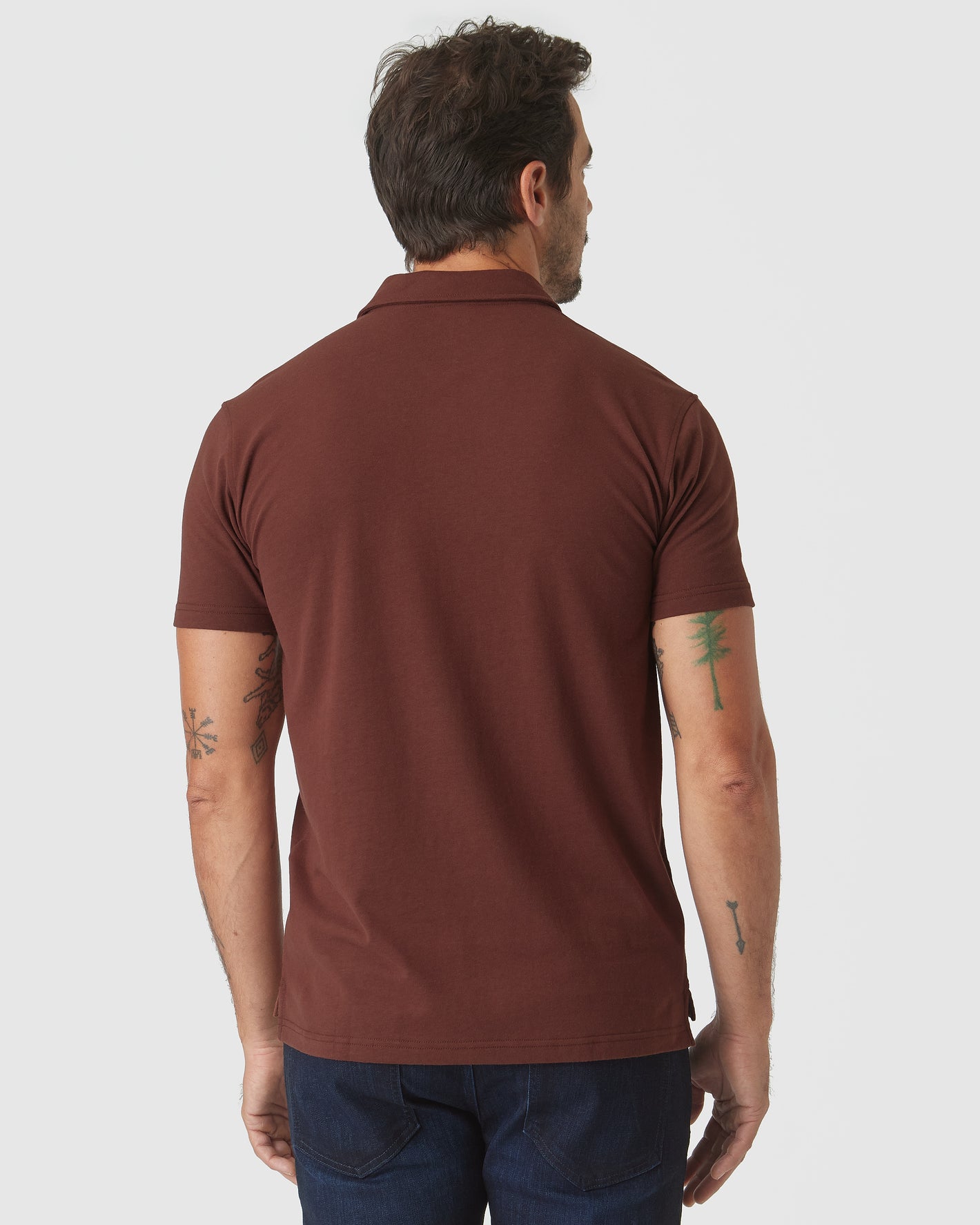 Back view of man in Dark Chocolate Classic Polo and jeans.