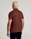 Dark Chocolate Short Sleeve Polo worn by man, back view.