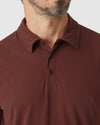 Man wearing Dark Chocolate Classic Polo with folded collar, three-button placket.