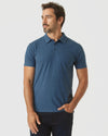 Man in Deep Sea Blue Heather Classic Polo, hand in pocket.
