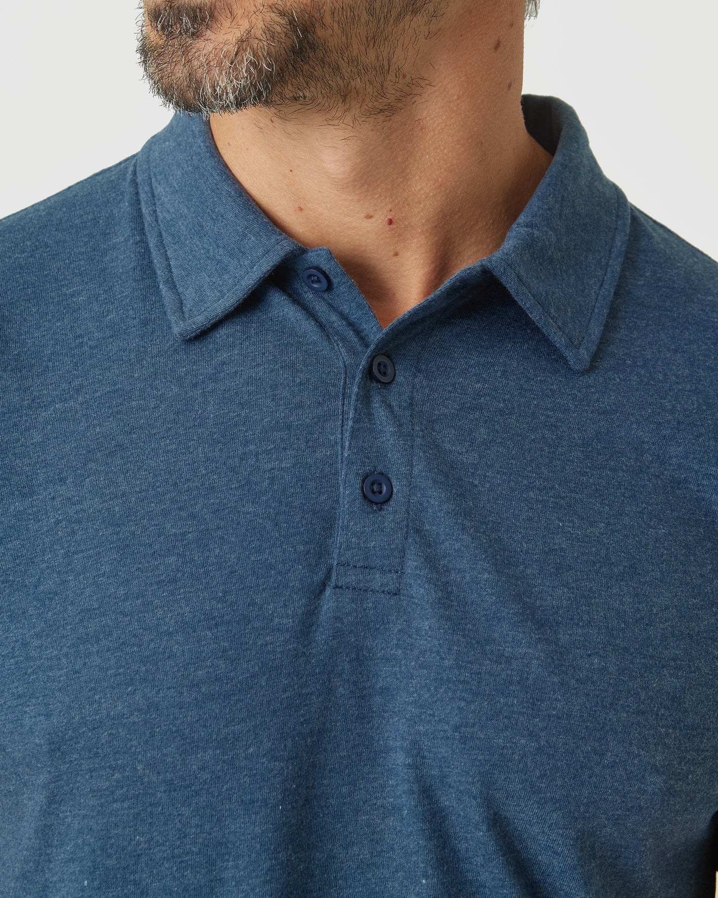 Man wearing Deep Sea Blue Heather Classic Polo shirt.