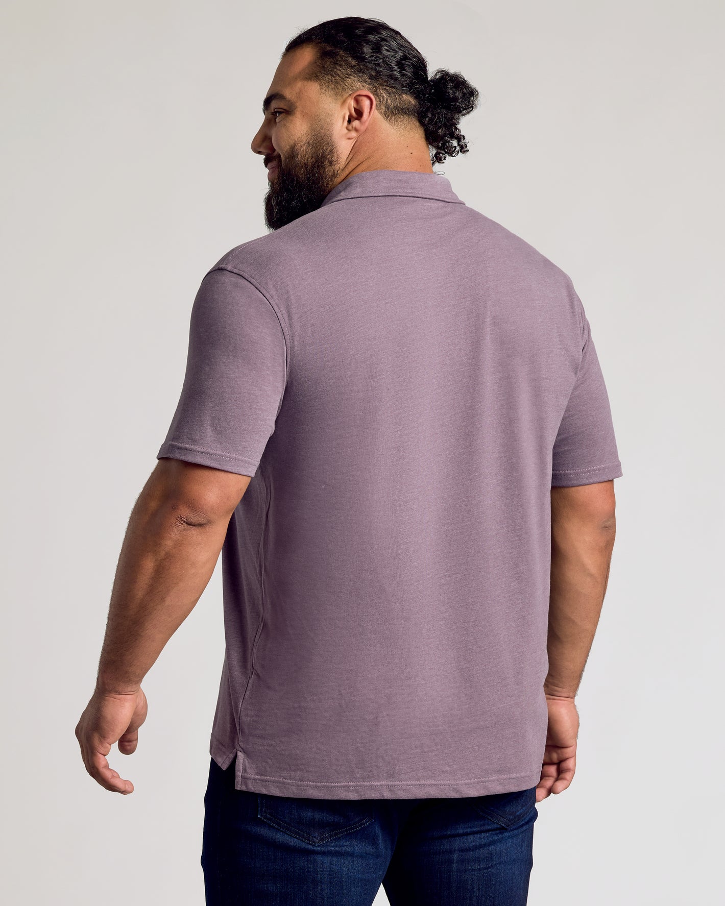 Back view of Dark Heather Amethyst Short Sleeve Polo on man.