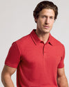 Man wearing Dark Heather Lava Short Sleeve Polo, looking at camera.