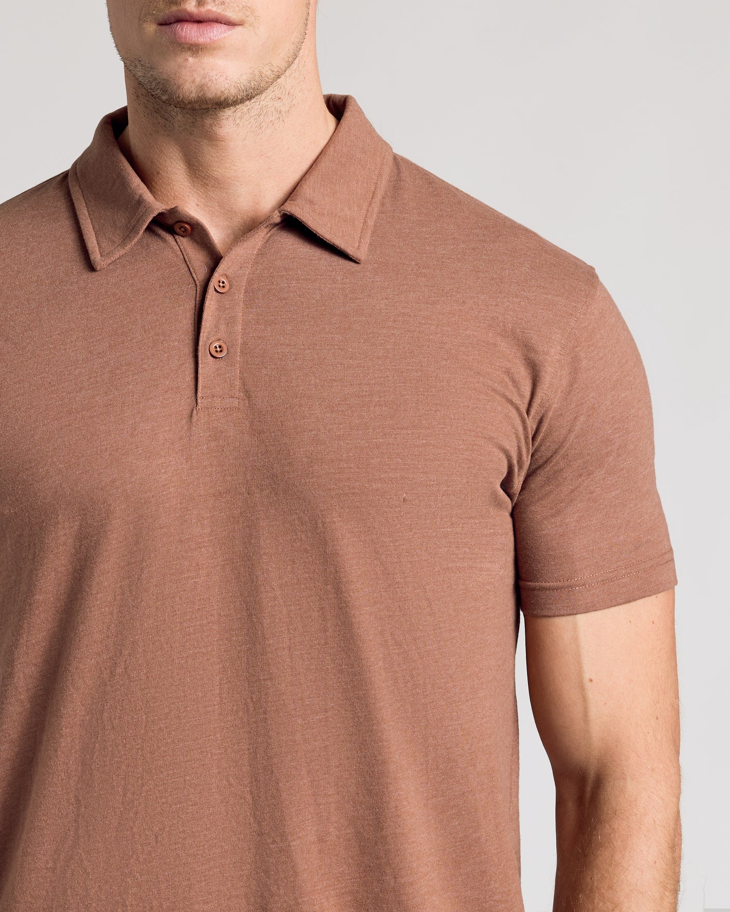 Man wearing Dark Heather Sepia Classic Polo, showcasing its fit and design.