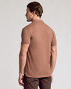 Man wearing Dark Heather Sepia Classic Polo, side profile view.