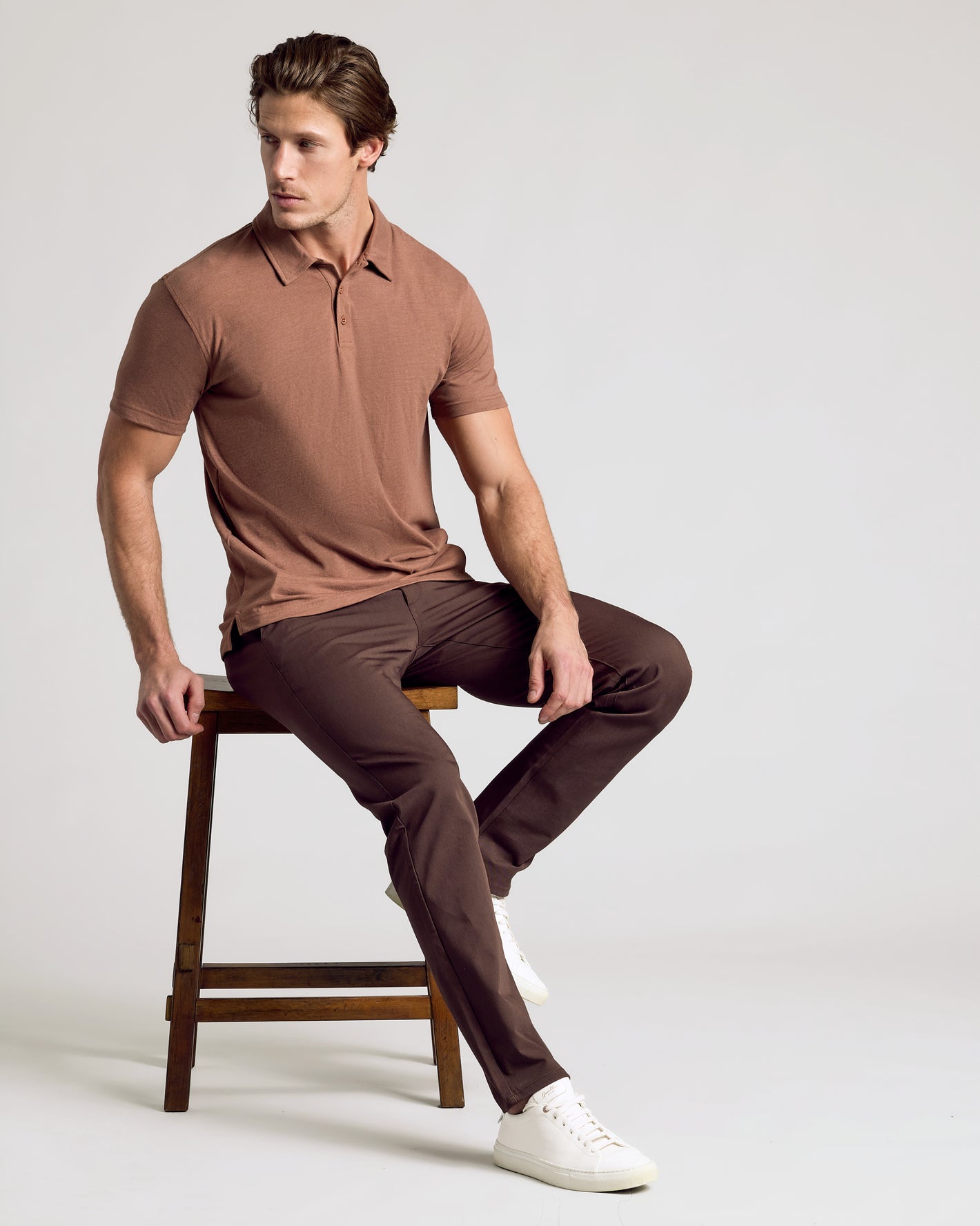Model in Dark Heather Sepia Classic Polo with slim-fit trousers.