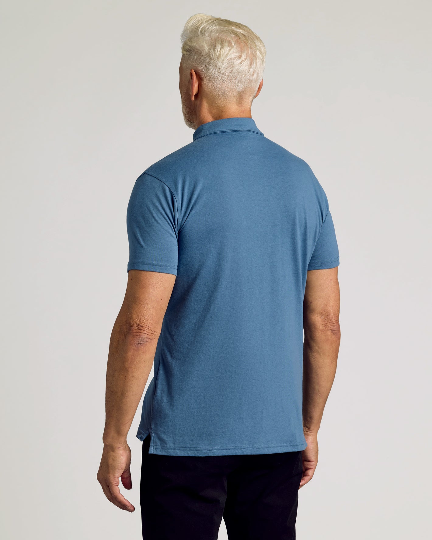 Back view of Fiord Classic Polo on man, showcasing fit and fabric.